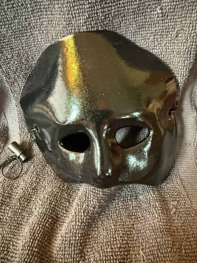 Handmade black clay masquerade mask with a lanyard
