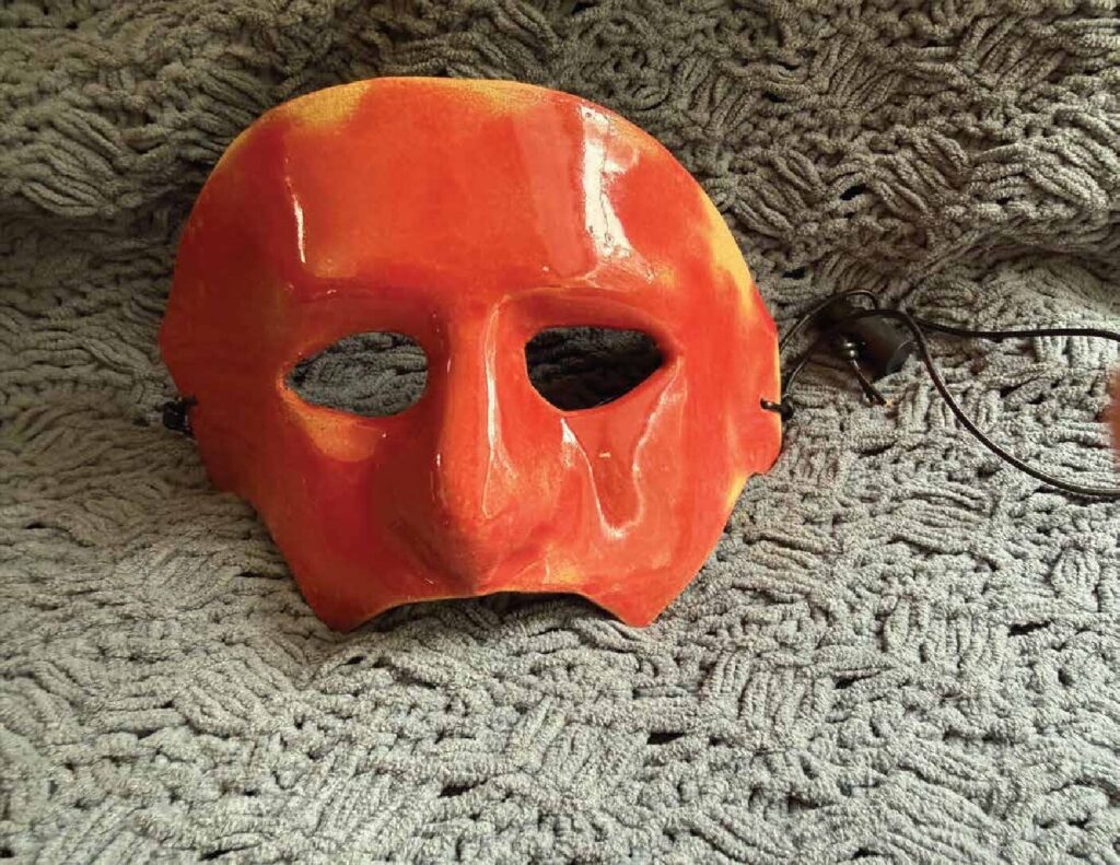 Handmade red clay masquerade mask with a lanyard