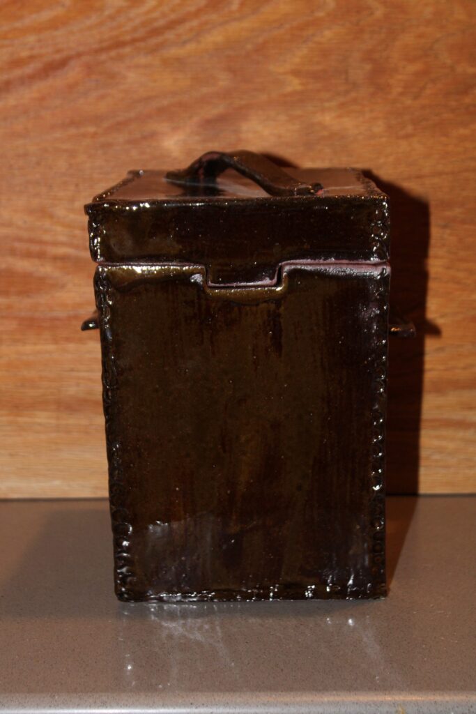 Square handmade ceramic canister with side handles in a dark brown glaze